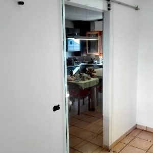 Porta scorrevole con sistema a vista in acciaio inox